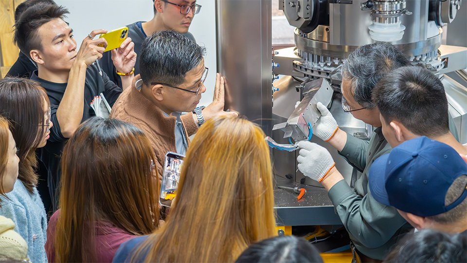 Yan is showing the discharge chute part kit