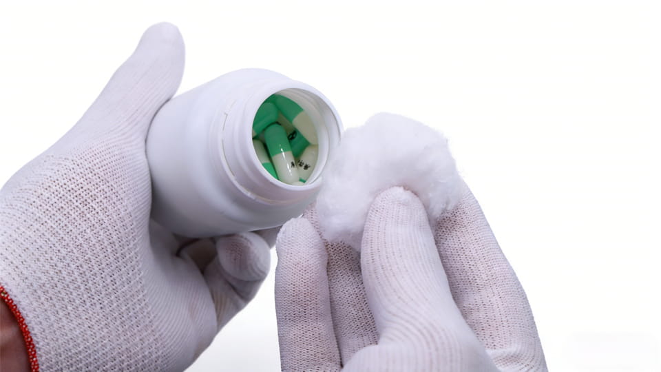 pill bottle with cotton in hand