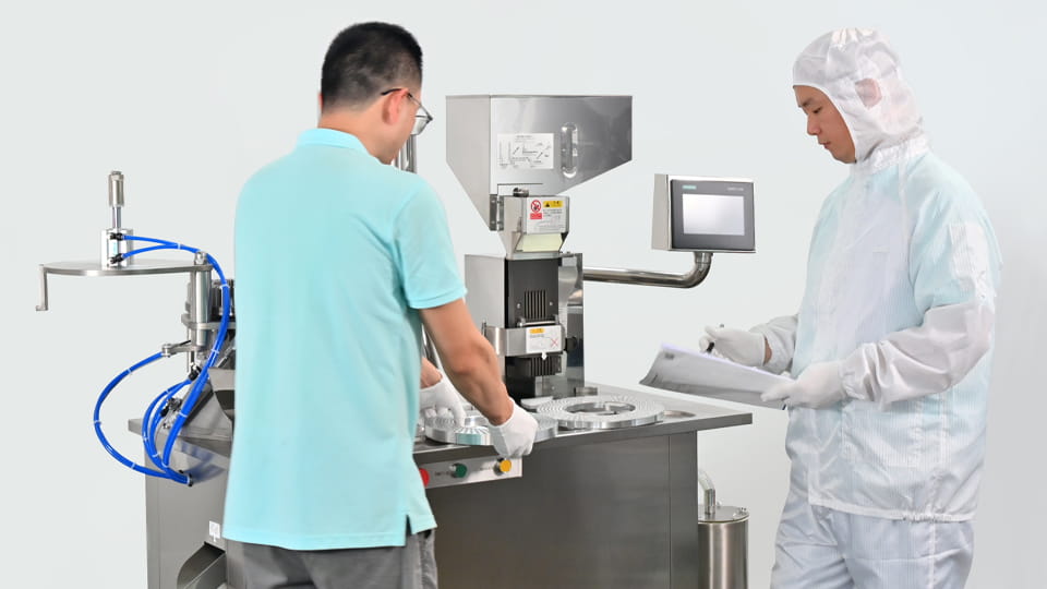 Workers are swapping the capsule machine mold