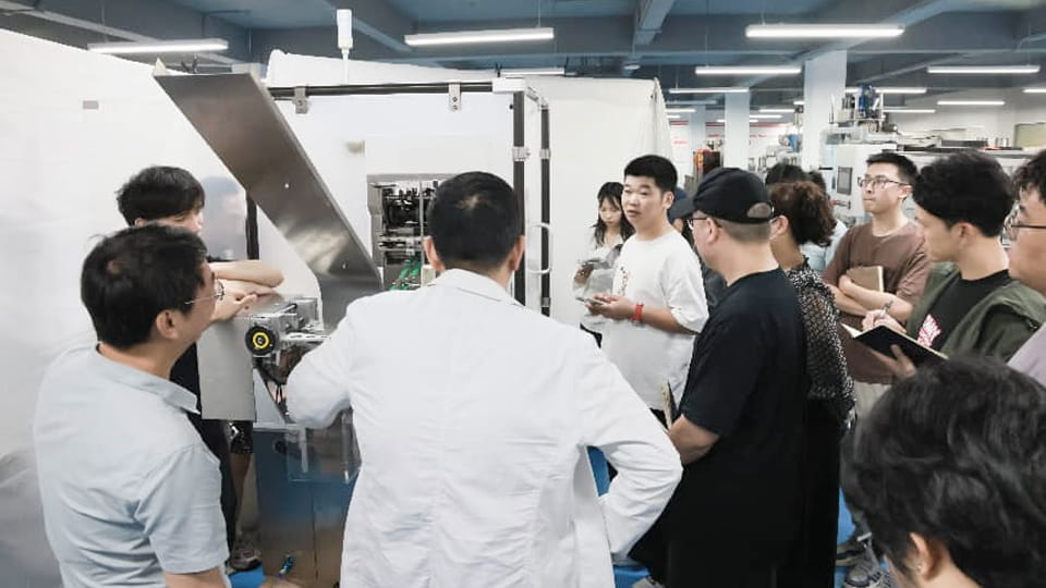 Engineer Huang explaining the suction carton and forming process