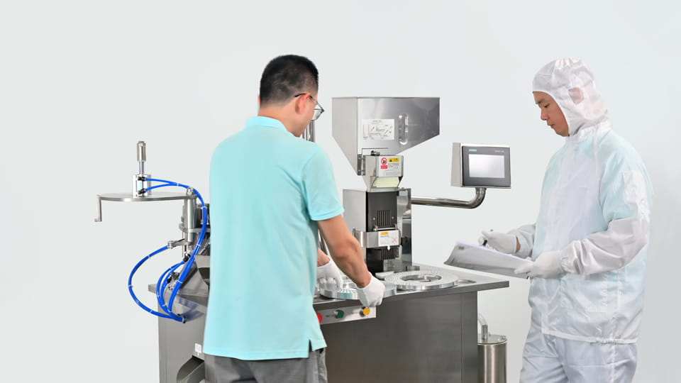 Technician maintaining stainless steel capsule filling machine