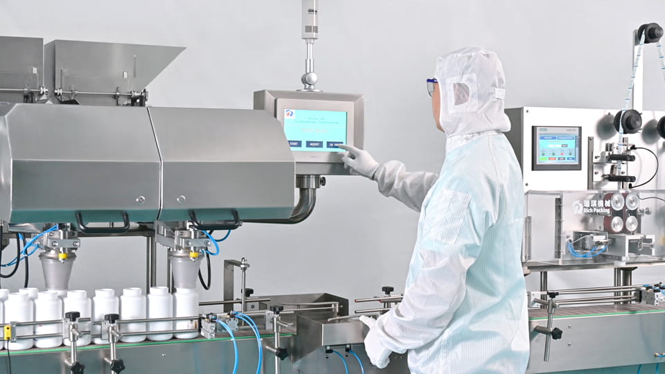Worker in protective suits operate a pharmaceutical packaging production line