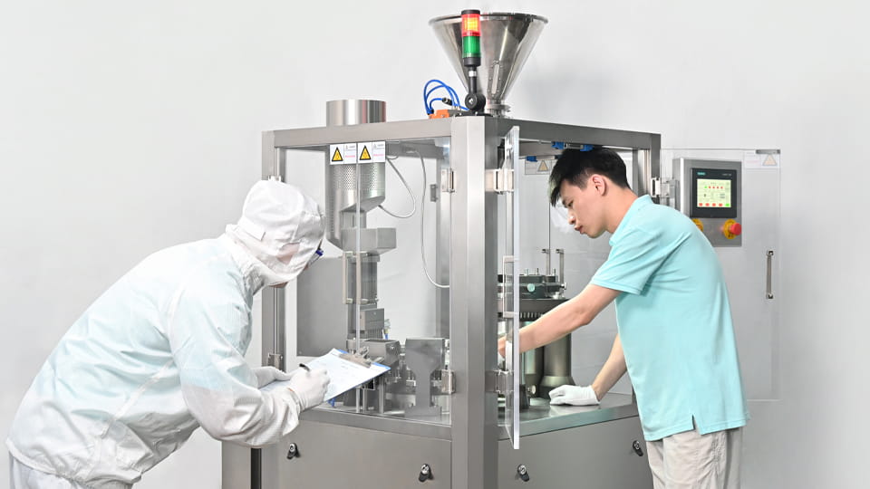 Workers are maintaining the capsule machine