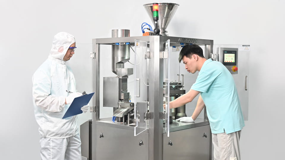 Workers are recording the operation of the capsule machine for GMP Requirements