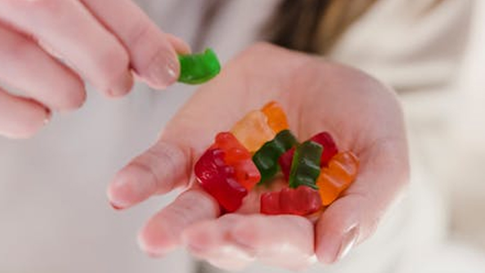 woman held a handful of Gummy Vitamins