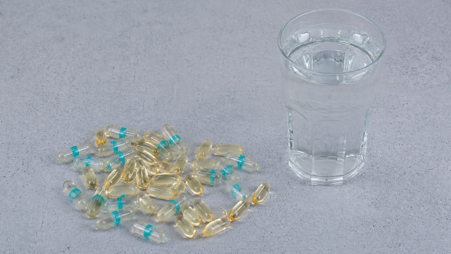 Liquid-Filled Capsules and Softgels with a glass of water