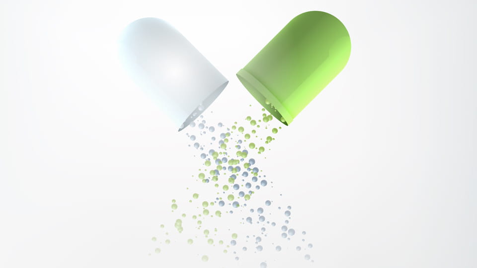 Illustration of an opened capsule shell releasing its fill particles, highlighting the difference between shell rupture and formulation-related capsule dissolution failure.