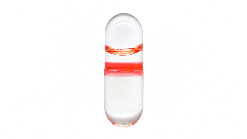 Capsule band sealing on a transparent two-piece hard capsule, with a colored sealing band around the cap-body joint.