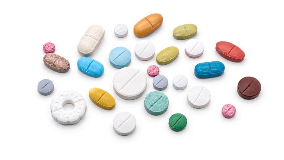 Various tablets with different shapes, sizes, and score lines
